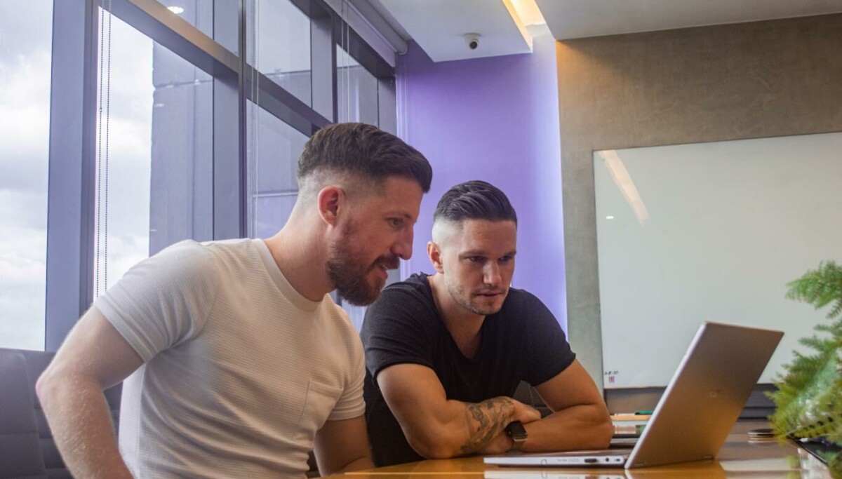 Stockifi co-founders reviewing data on a laptop